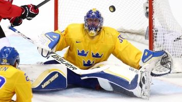 Swedish goalie Henrik Lundqvist makes a save during the 2014 Olympics.