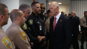 Florida Gov. Rick Scott Signs Gun Bill, NRA Sues To Stop It