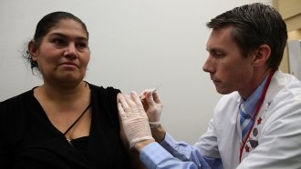 A woman receives a flu shot.