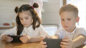 Children looking at cellphones