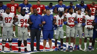 New York Giants coaches and players lock arms