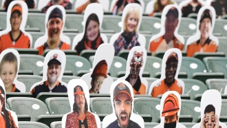 Cut-out fans sit in the stands during an NFL game between the Cincinnati Bengals and Los Angeles Chargers.
