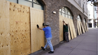 Laborers board up windows in Los Angeles, California.