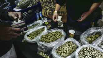 A vendor makes change for a marijuana customer at a cannabis marketplace in Los Angeles.