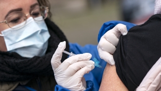 Nurse administers a vaccine injection.