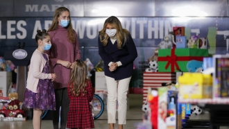 First lady Melania Trump visiting with children as she participates in the U.S. Marine Corps Reserve's Toys for Tots Drive