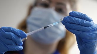 A nurse prepares a shot of the Pfizer-BioNTech COVID-19 vaccine.