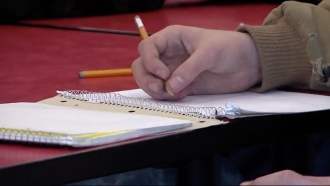 Student writes in a journal.