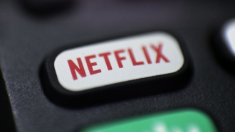 A Netflix logo on a remote control