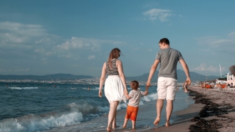 Family walks on the beach