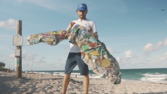 Man holds bag of trash