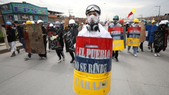 Protesters stand with their shields during an anti-government protest in Bogota, Colombia