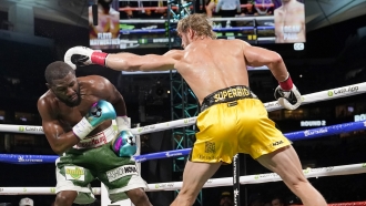 Floyd Mayweather, left, and Logan Paul fight during an exhibition boxing match at Hard Rock Stadium, Sunday, June 6, 2021.