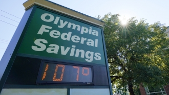 A display at an Olympia Federal Savings branch shows a temperature of 107 degrees Fahrenheit in Olympia, Wash.