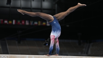 Simone Biles, of the United States, warms up prior to the artistic gymnastics balance beam final at the 2020 Summer Olympics.