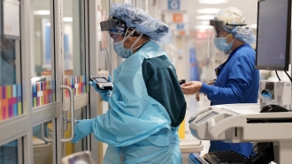 medical personnel don PPE while attending to a patient (not infected with COVID-19) at Bellevue Hospital in New York