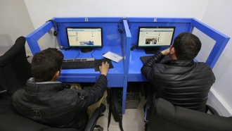 Afghanis access social media websites at a private internet cafe in Kabul, Afghanistan