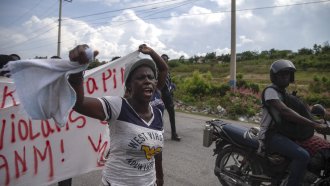 People protest for the release of the kidnapped missionaries near the missionaries' headquarters in Titanyen
