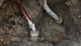 A copper water supply line and a lead pipe in the ground