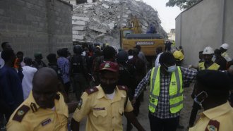 Rescue workers at the site of the 21-story high-rise apartment building collapse in Lagos, Nigeria.