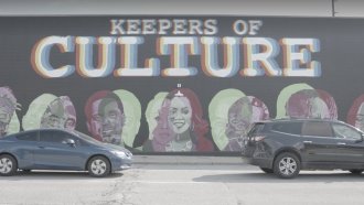 A mural is painted on the side of a building in Indianapolis.