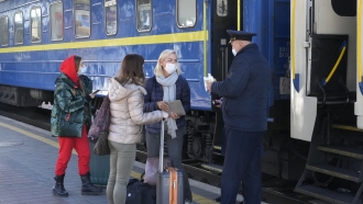 Train conductor checks COVID Certificates.