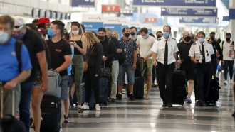 A line of passengers at an aiport