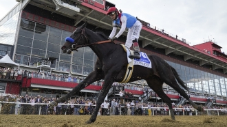 John Velazquez atop Medina Spirit competes during the 146th Preakness Stakes horse race at Pimlico Race Course