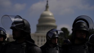 Police in riot gear patrol near the U.S. Capitol in Washington.