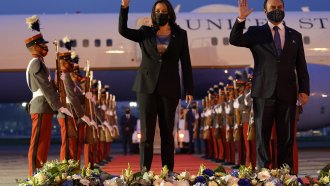 Vice President Kamala Harris and Guatemala's Minister of Foreign Affairs Pedro Brolo wave in Guatemala City.