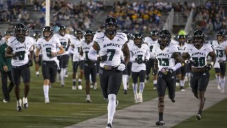 The Hawaii team takes the field before an NCAA college football game against Nevada.