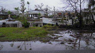 A damaged oyster boat sits amongst destruction along Bayou Pointe au Chien in the aftermath of Hurricane Ida.