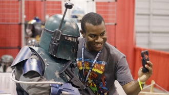 Christopher Parker takes a selfie with a Boba Fett character at the Motor City Comic Con, Friday, May 13, 2016 in Novi, Mich.