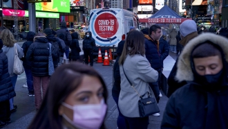 People wait in a long line to get tested for COVID-19 in Times Square, New York