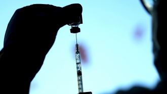 A dose of a Pfizer COVID-19 vaccine is prepared