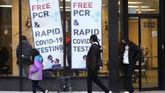 People leave a free PCR & Rapid COVID-19 testing site