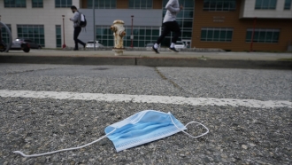 A discarded face mask lies in the street in San Francisco.