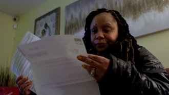 A woman looks at her loan statements.