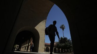Pedestrians walk on the campus at Stanford University in Stanford, California.