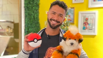 Man holding dog that looks like a Pokemon character