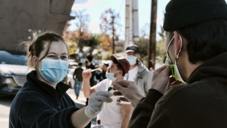 A man is handed a swab for a Covid-19 rapid test.