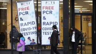 People leave a free PCR & rapid COVID-19 testing site in Chicago