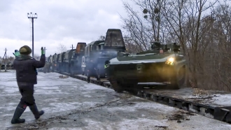 A Russian armored vehicle drives off a railway platform