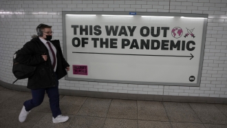 Sign reading "This Way Out of the Pandemic"