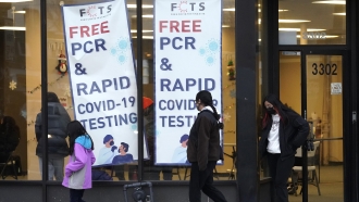 People leave a free PCR & RAPID COVID-19 testing site in Chicago