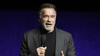 Arnold Schwarzenegger speaking on stage.