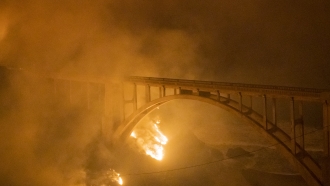 Colorado Fire burns along below Rocky Creek Bridge on Highway 1 near Big Sur, California.
