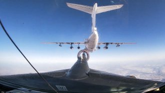 Russian Il-76 air tanker, top, is refueling a Russian Tu-95MS.