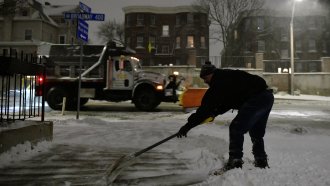 A man shovels snow in Somerville, Mass.
