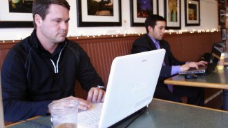 Man on computer in a coffee shop